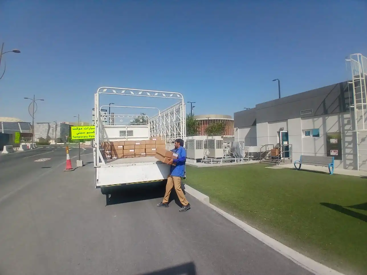 Worker loading boxes onto truck for commercial move in Dubai