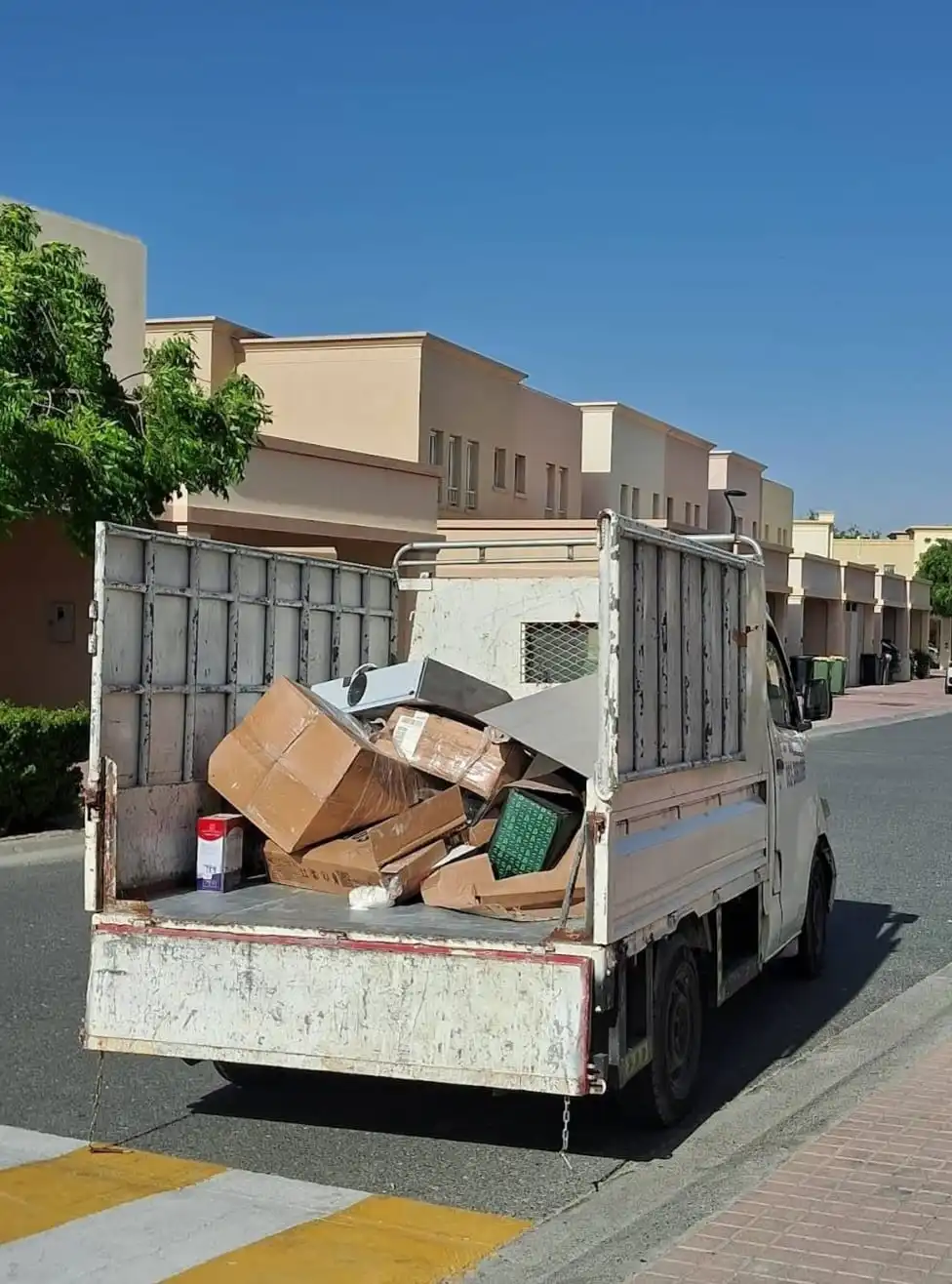 Truck loaded with junk boxes on residential street in Dubai
