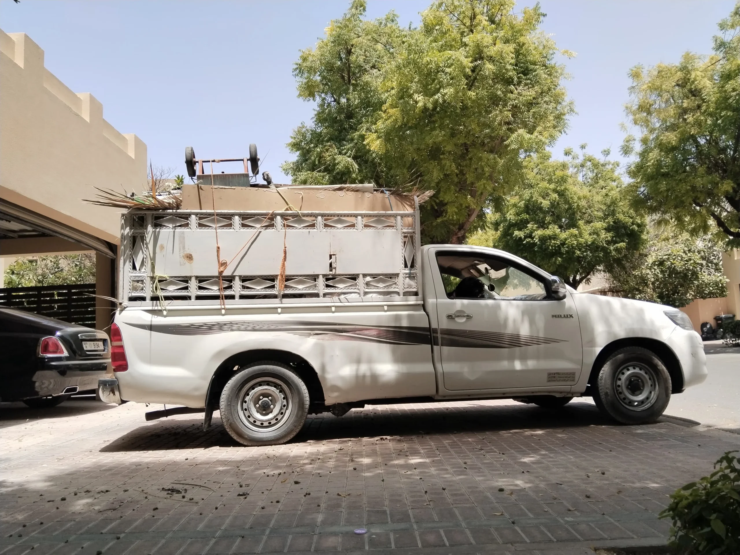 Pickup truck loaded with garden waste and junk in Dubai